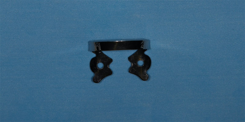 efrver No. 2 rubber dam clamp used for isolating premolars during restorative procedures.