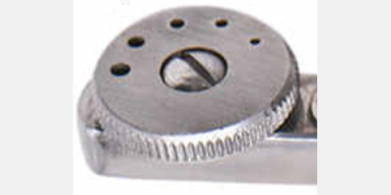 efrver Close-up of the rotating wheel on an Ainsworth rubber dam punch showing multiple hole sizes for different teeth
