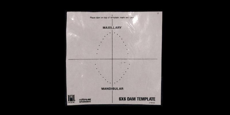 efrver Stock rubber dam template showing recommended hole positions for maxillary and mandibular tooth isolation.