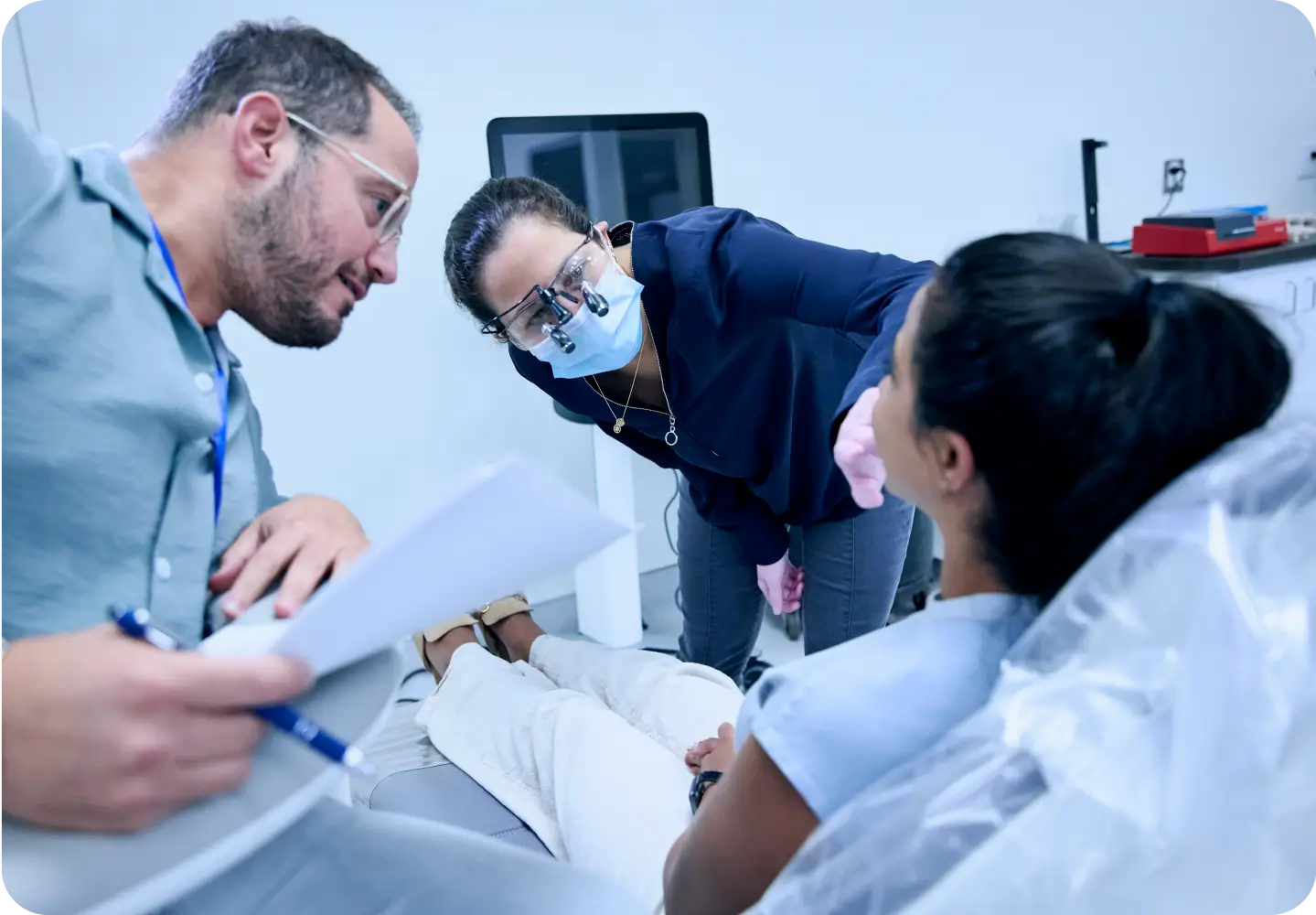 Two dentists examining a patient.