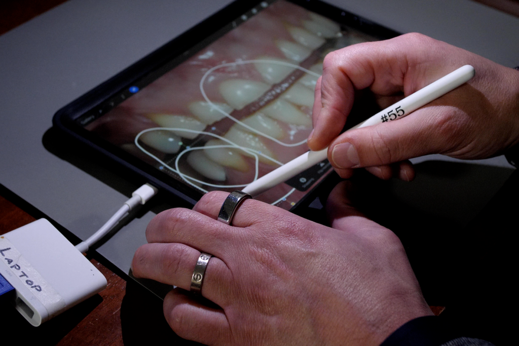 Dentist using tablet and stylus for advanced dental treatment planning and digital smile design
