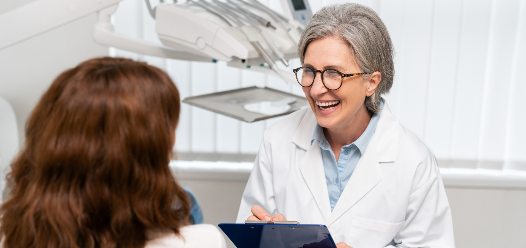 efrver Dentist smiling during a patient consultation while discussing treatment options and how to improve dental case acceptance