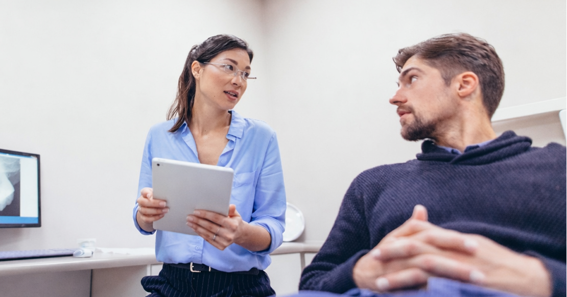 Proven Ways to Improve Dental Case Acceptance Dental professional reviewing treatment recommendations with a patient to improve dental case acceptance