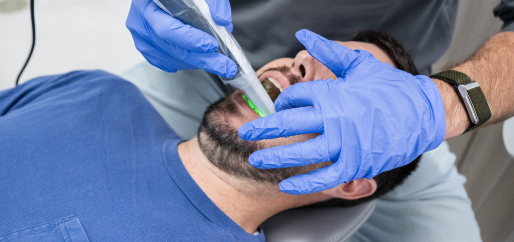 AI in Dental Diagnostics for Stronger Case Acceptance Dentist using an iTero intraoral scanner as part of an AI in dental diagnostics workflow.