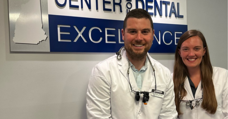 Spear Digest Dr. Andy Janiga and his associate, Dr. Kayla Sargent, standing together at the Center for Dental Excellence, an example of dental mentorship for new dentists in practice.