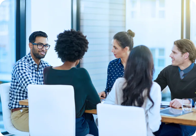 Dentists talking around a table at a Spear study club meeting